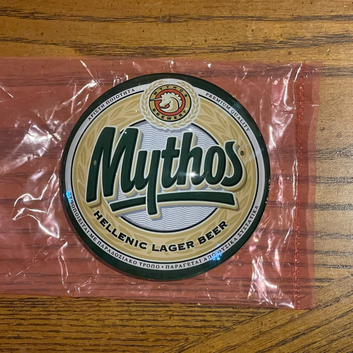 Mythos badge in its packaging