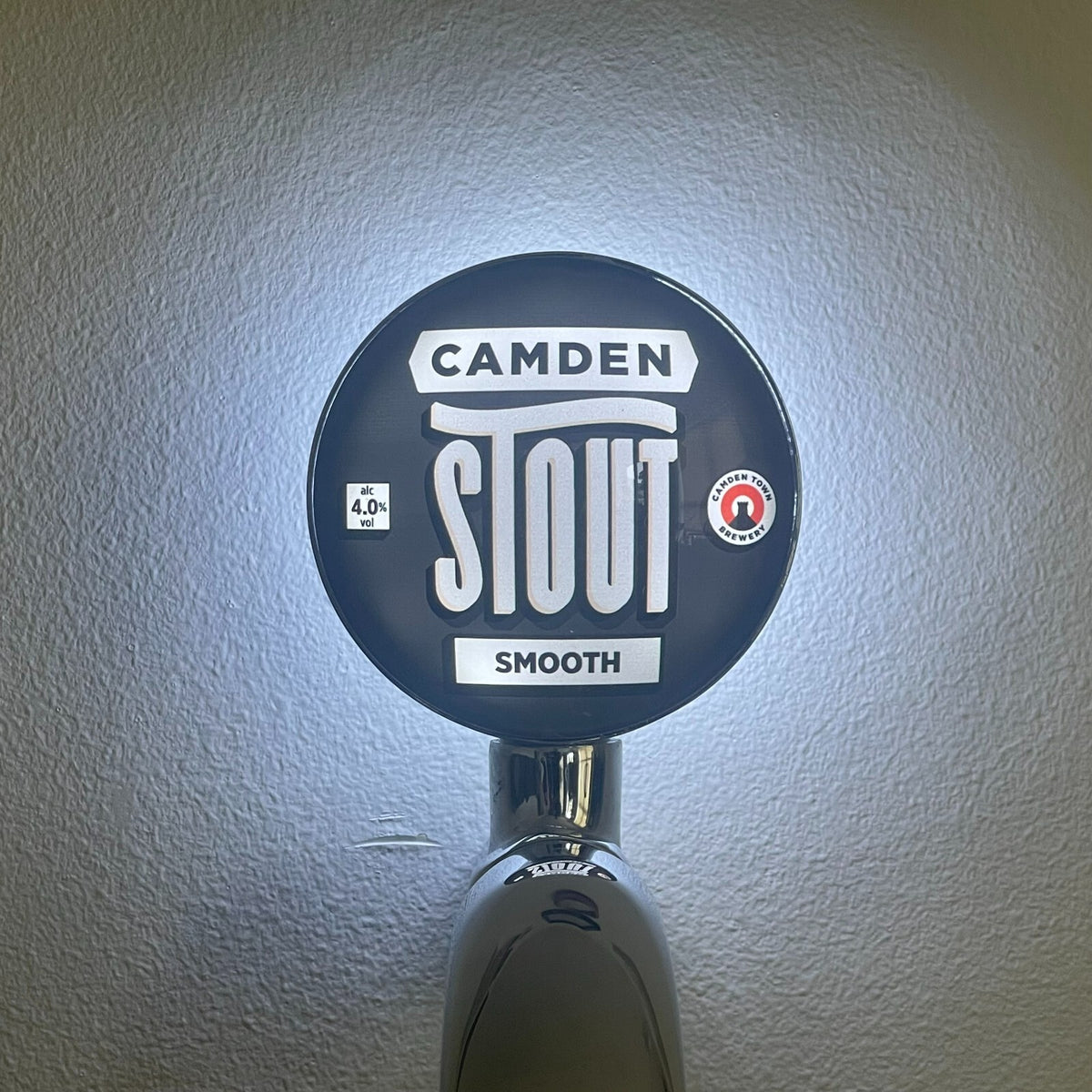 Camden Stout badge lit up on a beer tap
