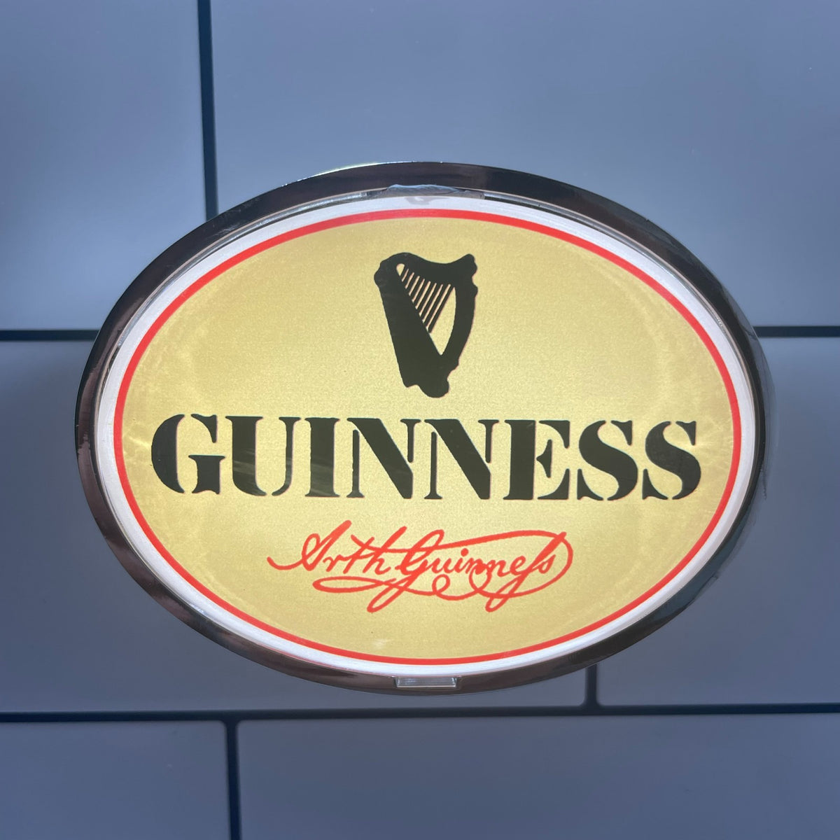 Retro Cream Guinness (1978) oval badge lit up on a beer tap