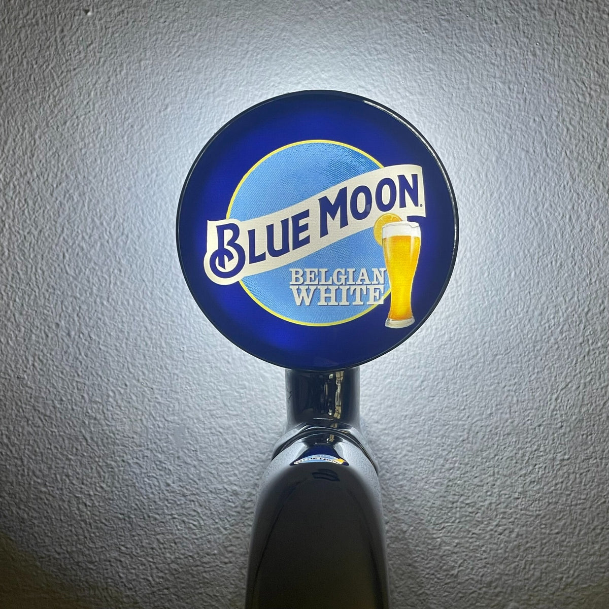 Blue Moon badge lit up on a beer tap