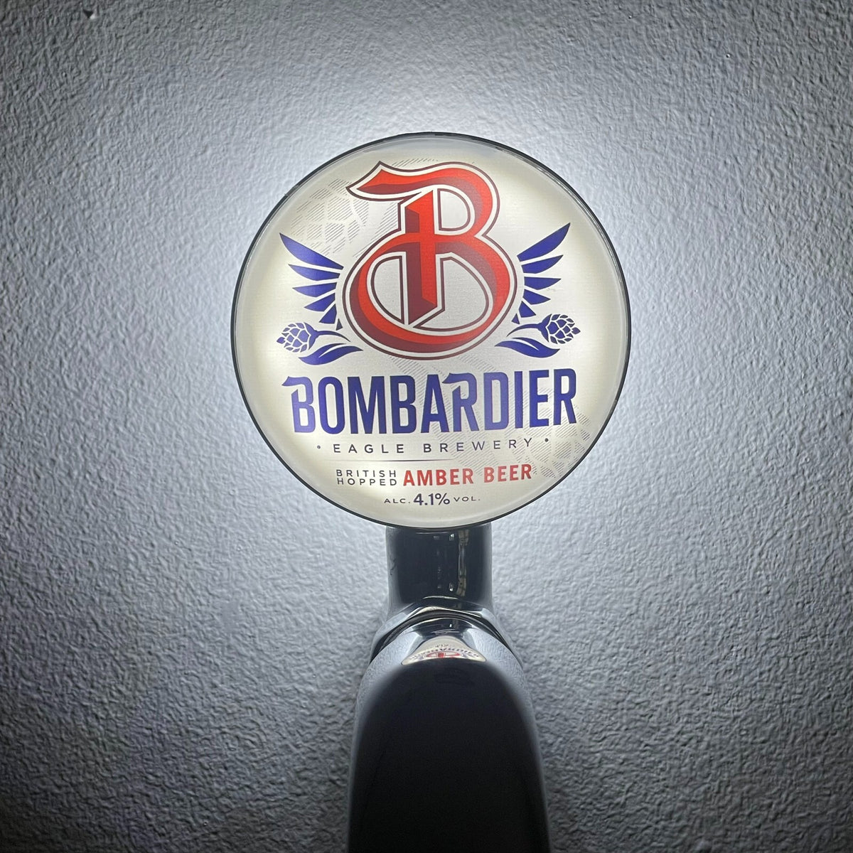 Bombardier badge lit up on a beer tap
