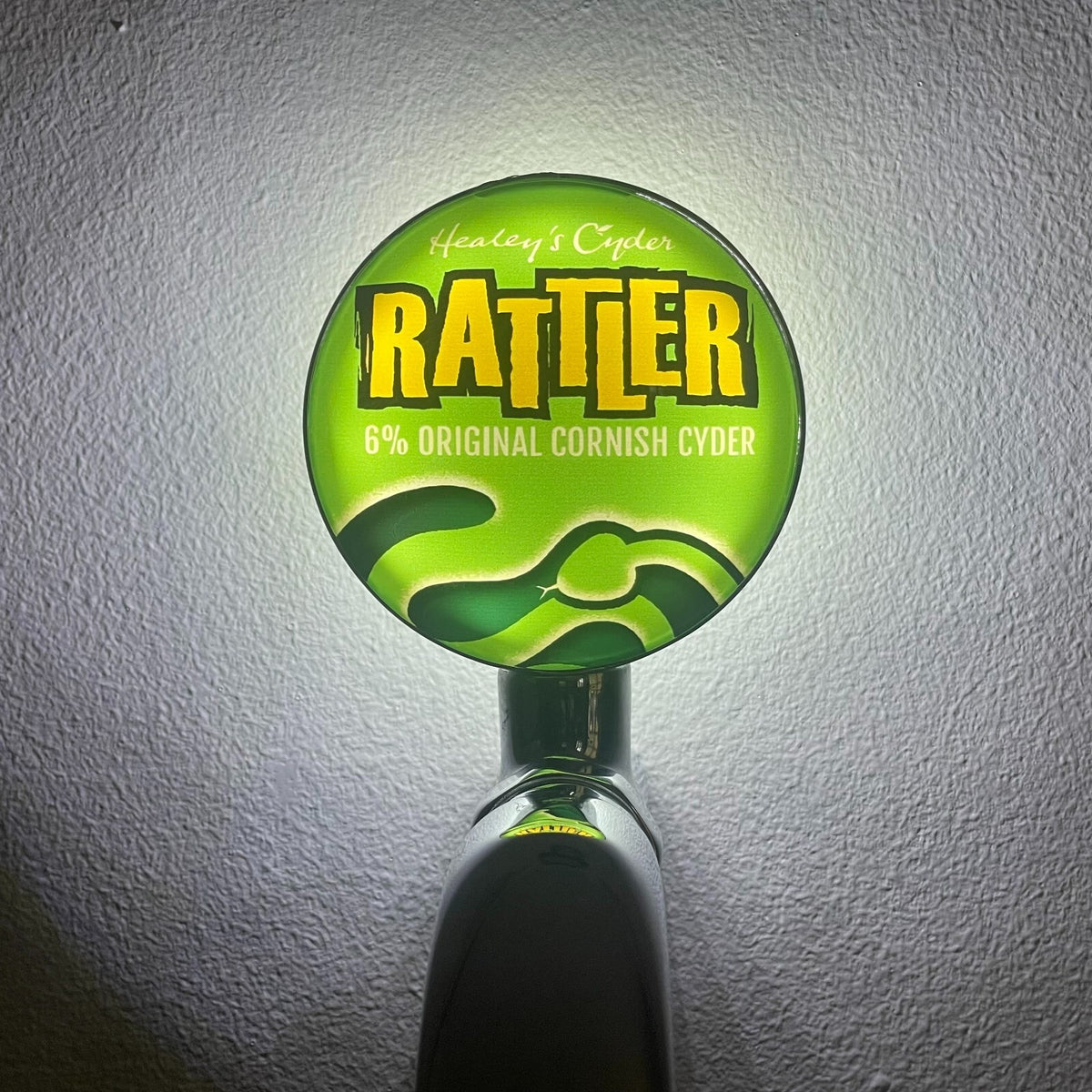 Rattler Cyder badge lit up on a beer tap