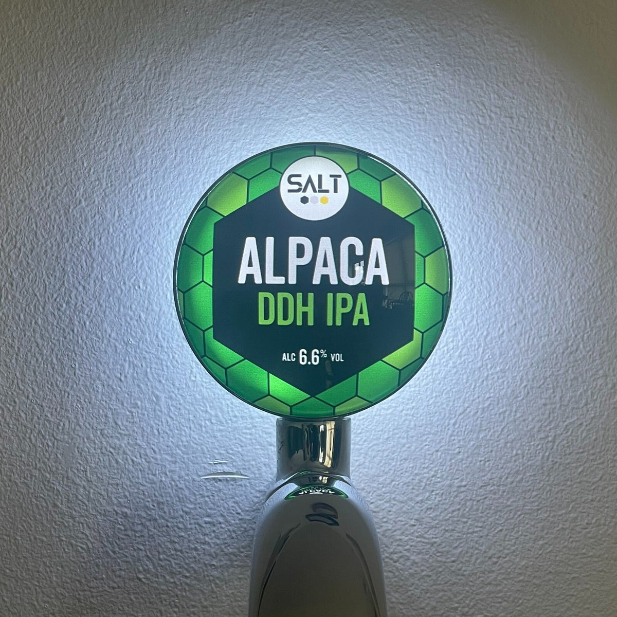 Salt Alpaca DDH IPA badge lit up on a beer tap
