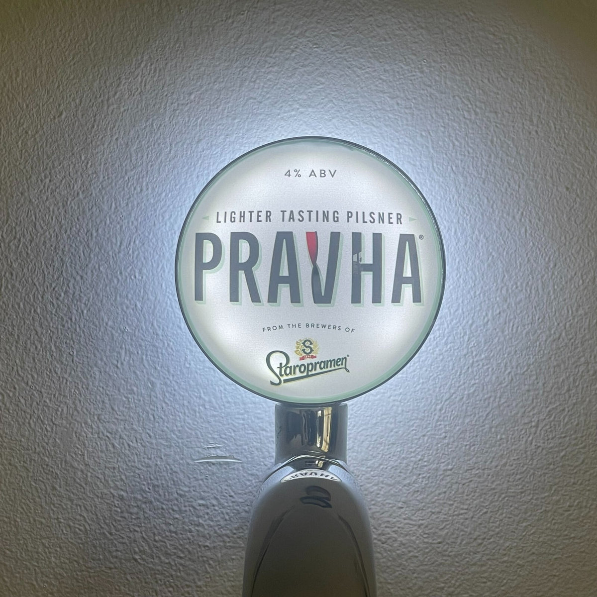 Pravha badge lit up on a beer tap