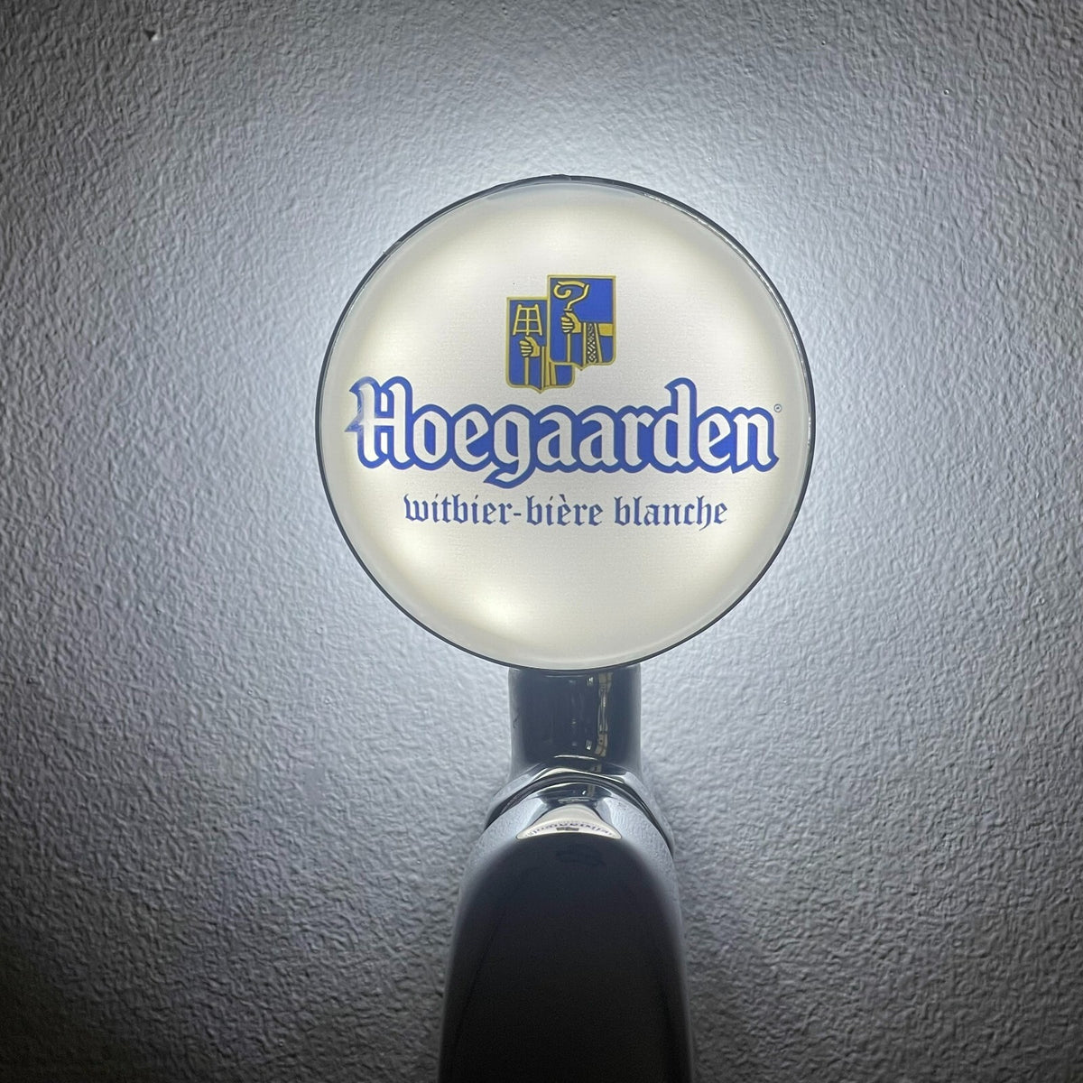 Hoegaarden badge lit up on a beer tap
