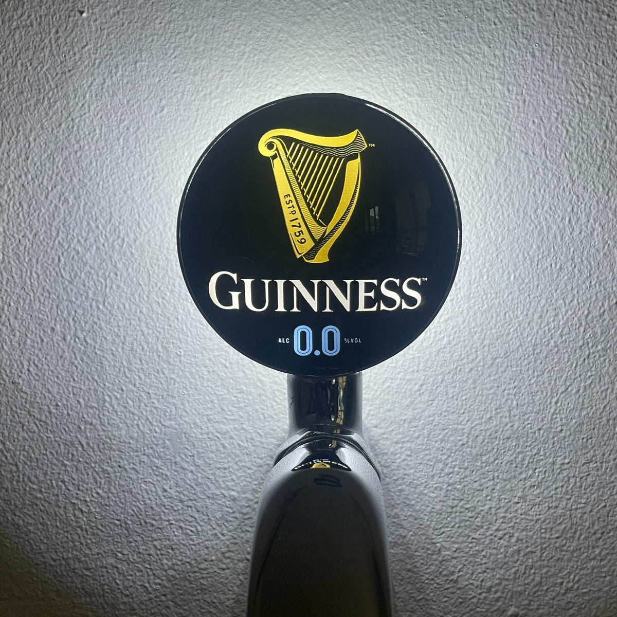 Guinness 0.0 badge lit up on a beer tap