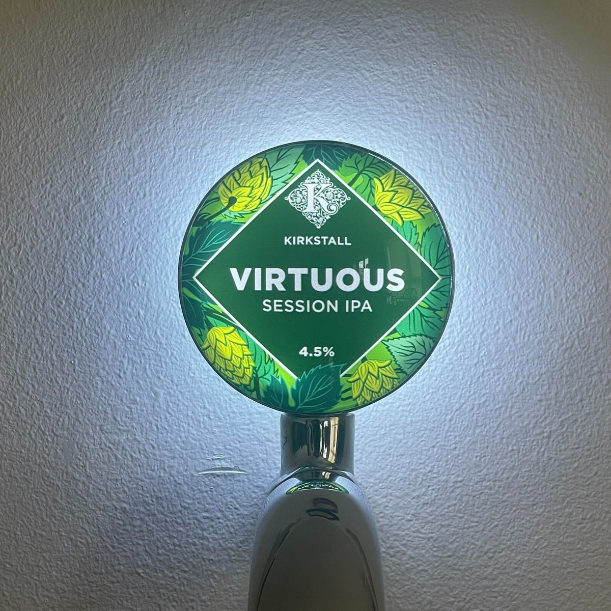 Kirkstall Virtuous badge lit up on a beer tap