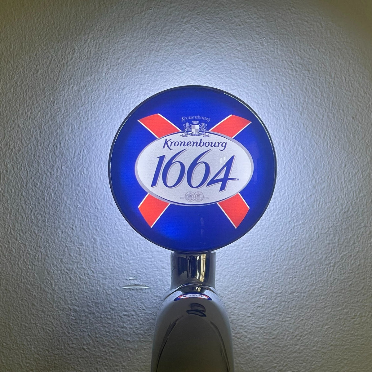Kronenbourg 1664 badge lit up on a beer tap