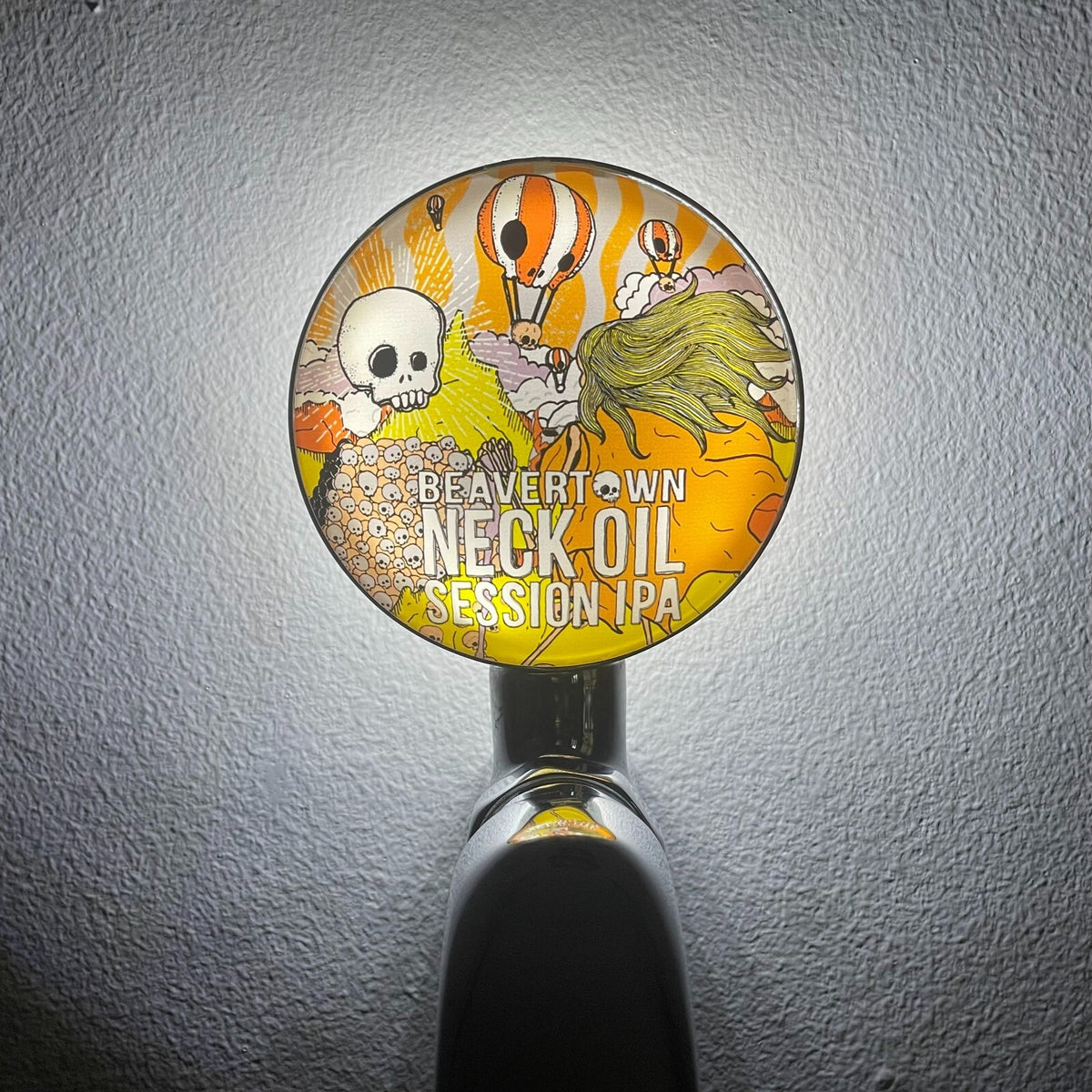 Beavertown Neck Oil badge lit up on a beer tap