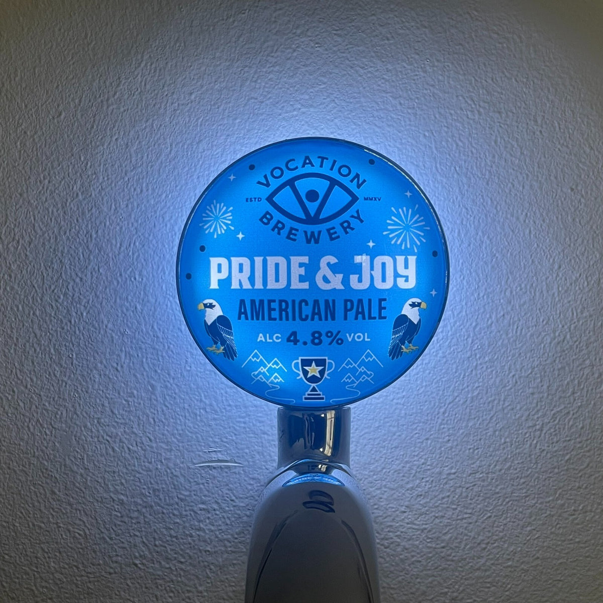 Vocation Pride & Joy badge lit up on a beer tap