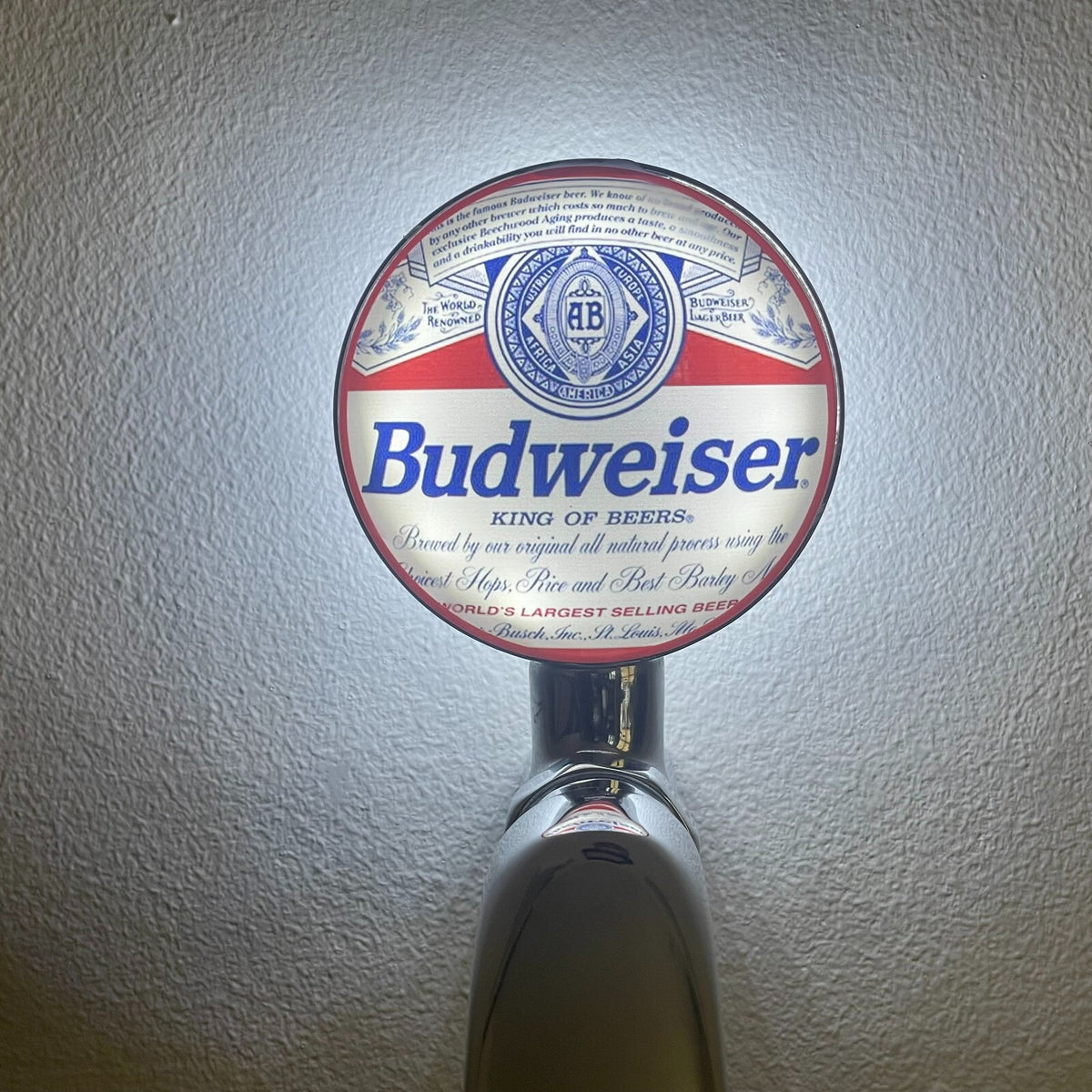 Budweiser badge lit up on a beer tap
