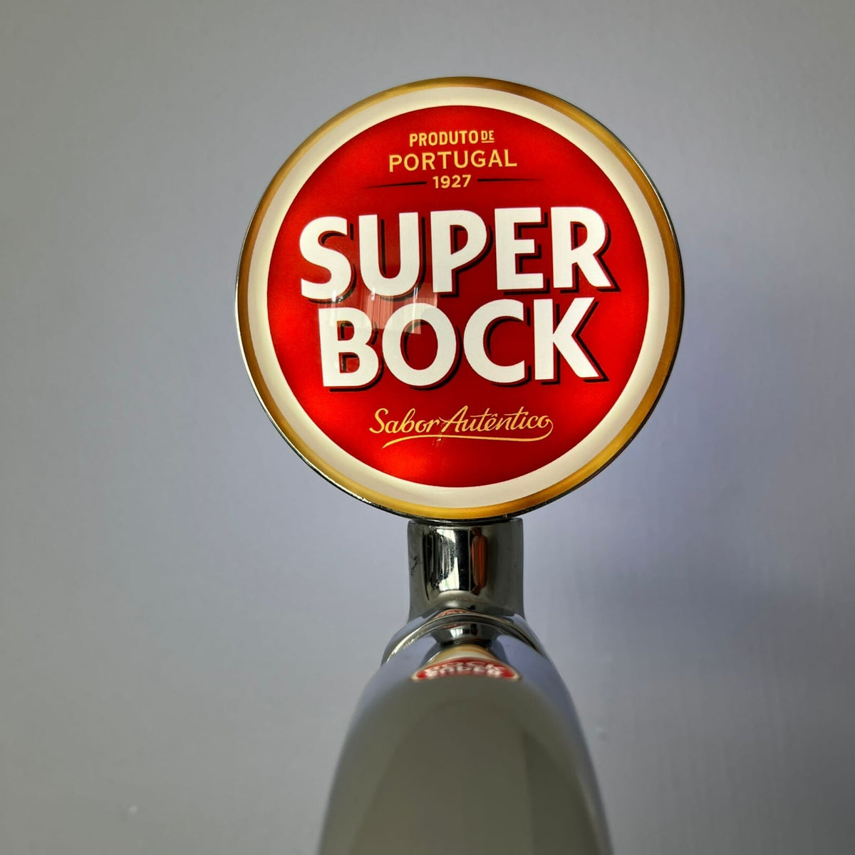 Super Bock badge lit up on a beer tap