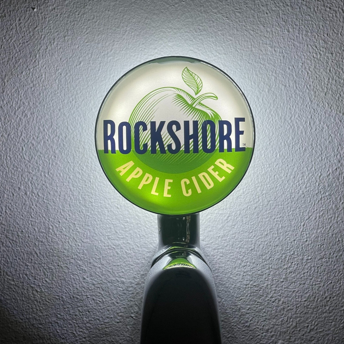 Rockshore Apple Cider badge lit up on a beer tap