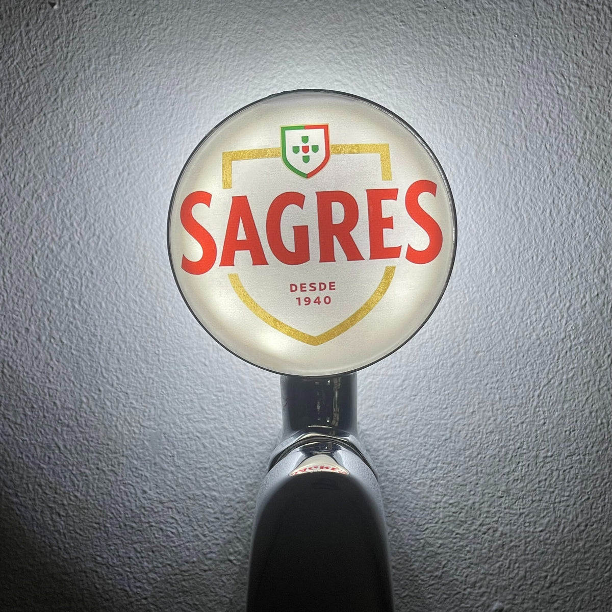 Sagres badge lit up on a beer tap