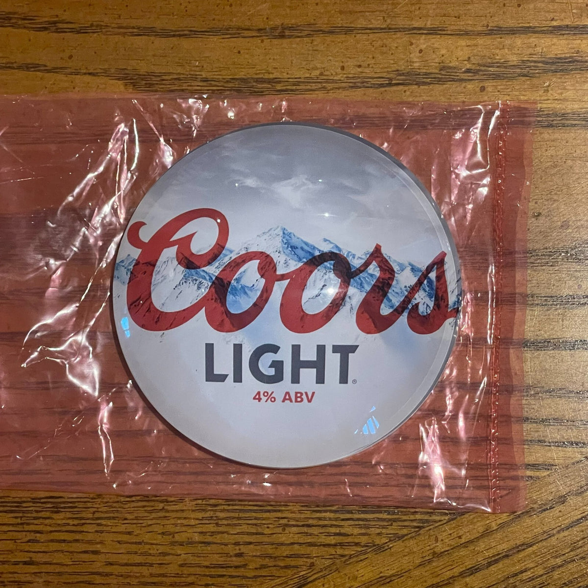 Coors Light badge in its packaging