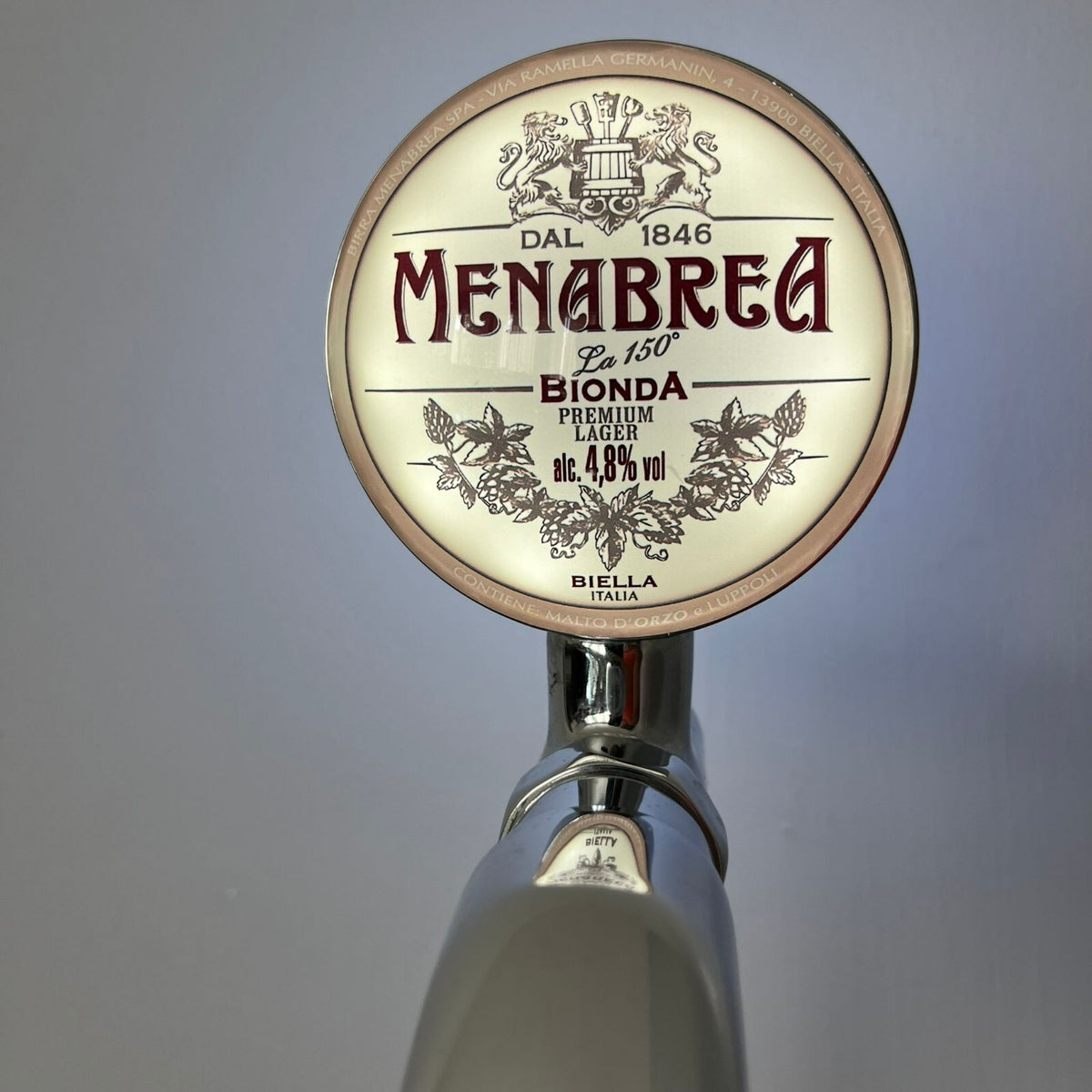 Menabrea badge lit up on a beer tap