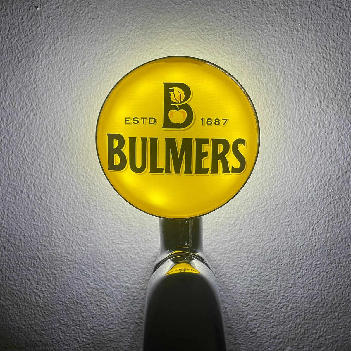 Bulmers badge lit up on a beer tap