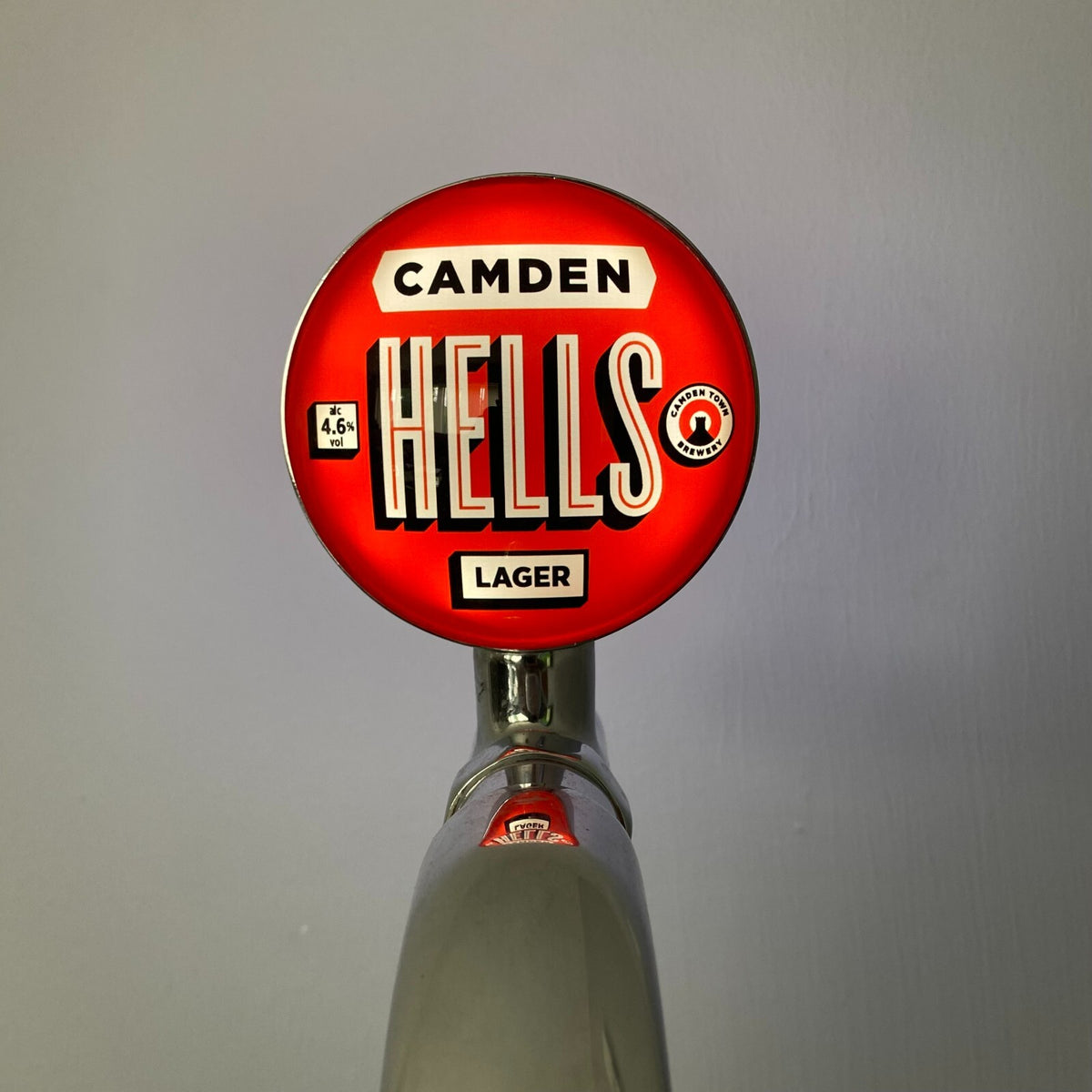 Camden Hells Lager badge lit up on a beer tap