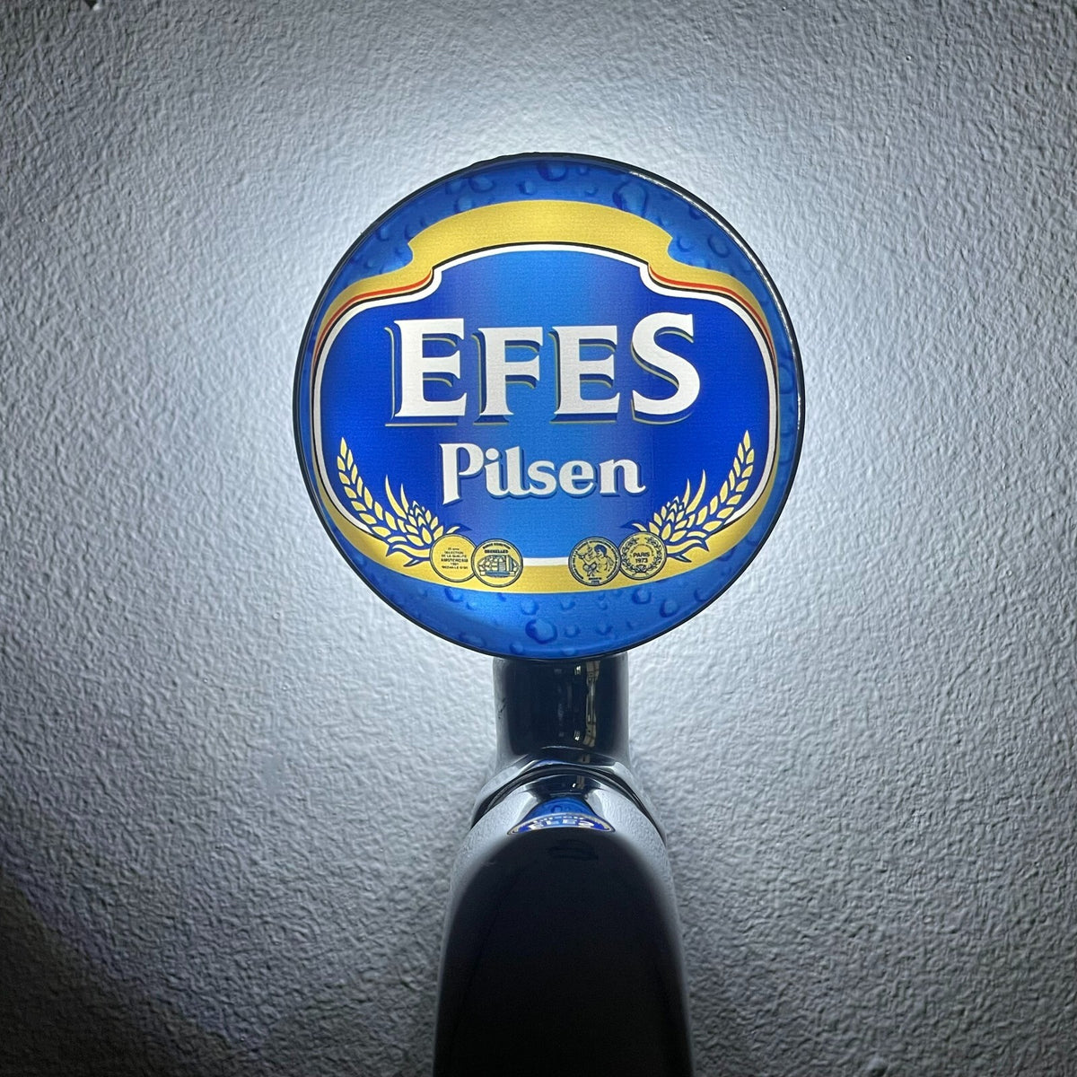 Efes Pilsner badge lit up on a beer tap