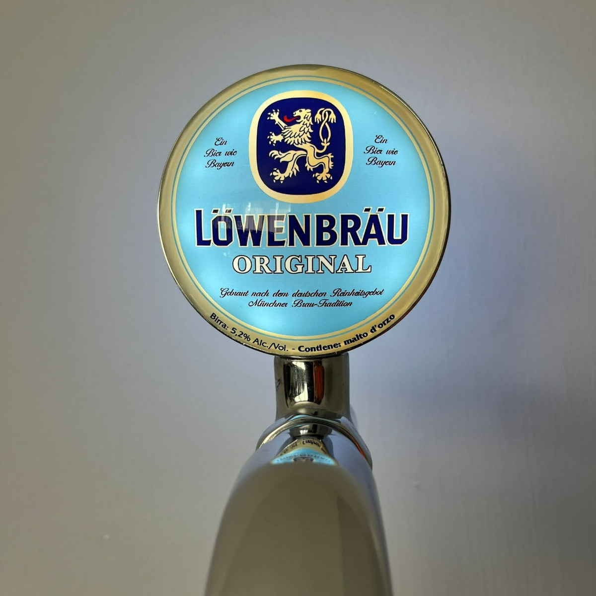 Löwenbräu badge lit up on a beer tap