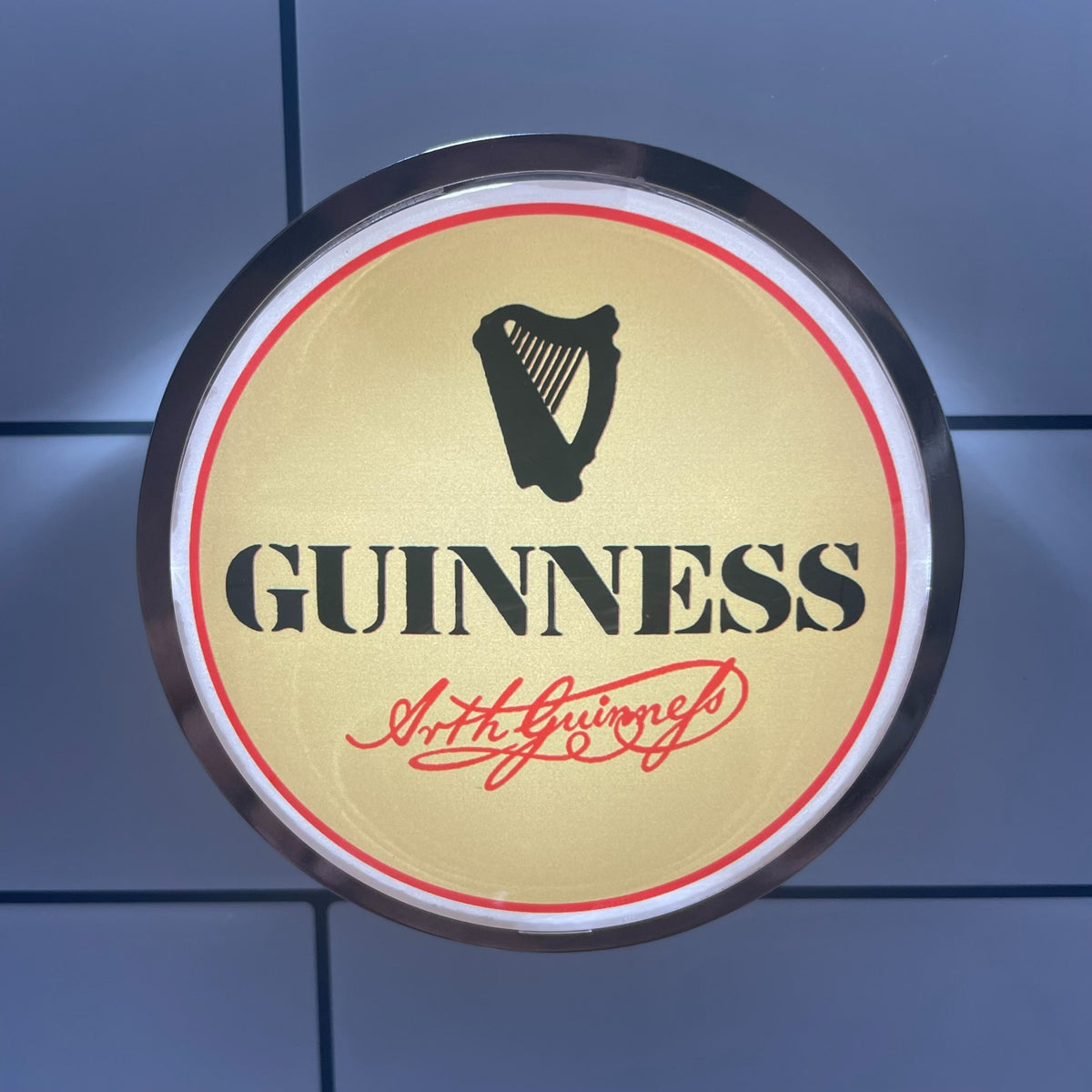 Retro Cream Guinness (1978) badge lit up on a beer tap
