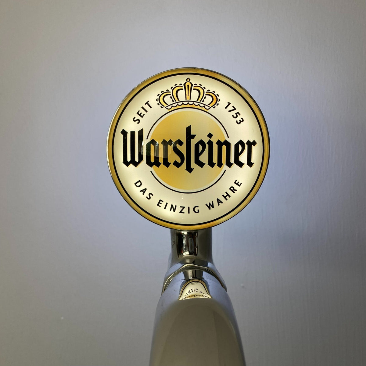 Warsteiner badge lit up on a beer tap