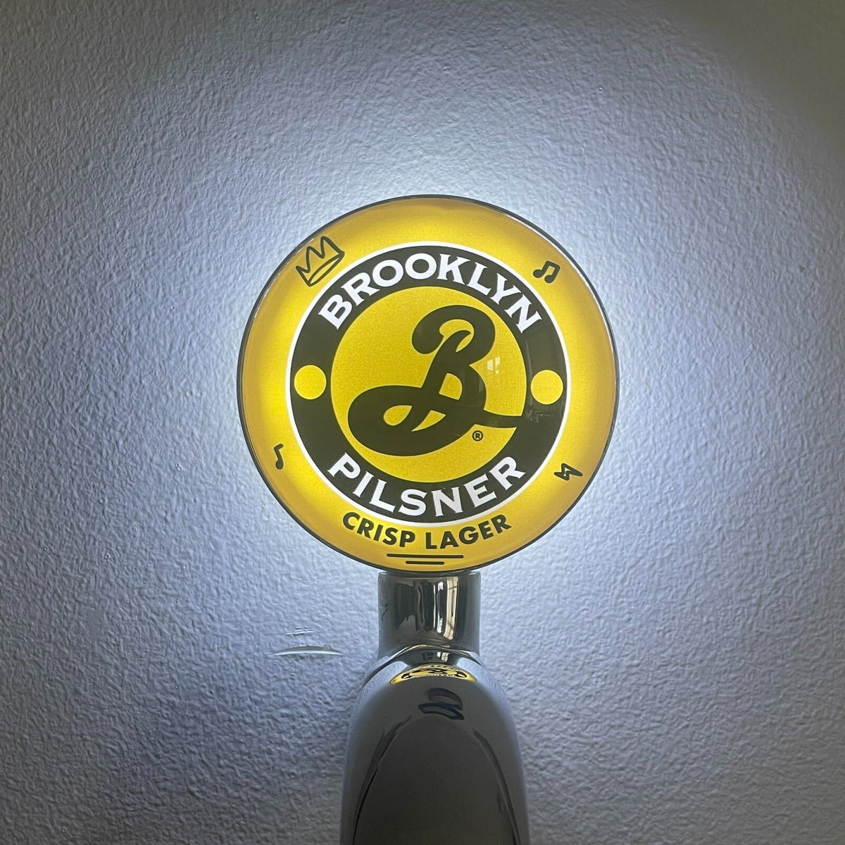 Brooklyn Pilsner badge lit up on a beer tap