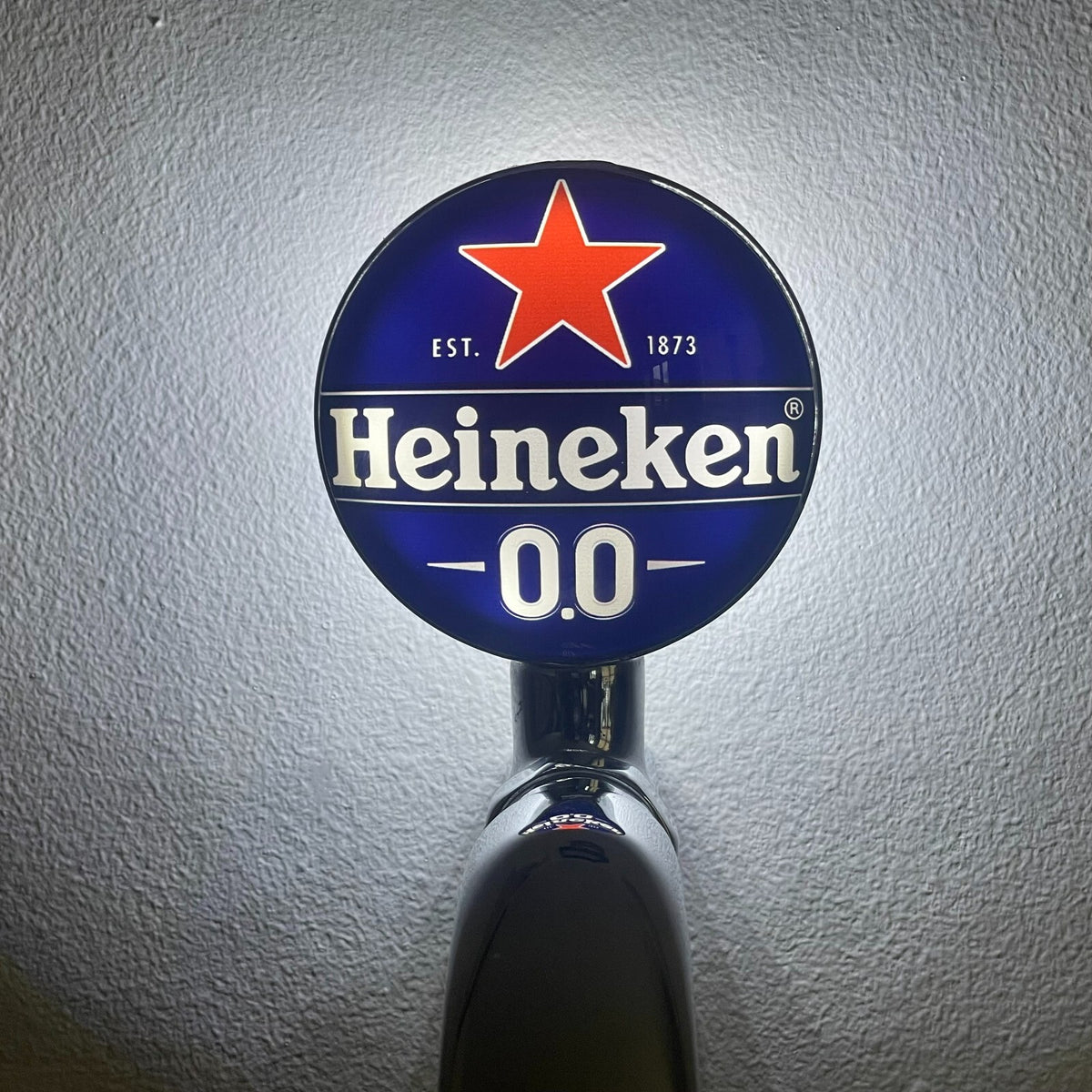 Heineken 0.0 badge lit up on a beer tap