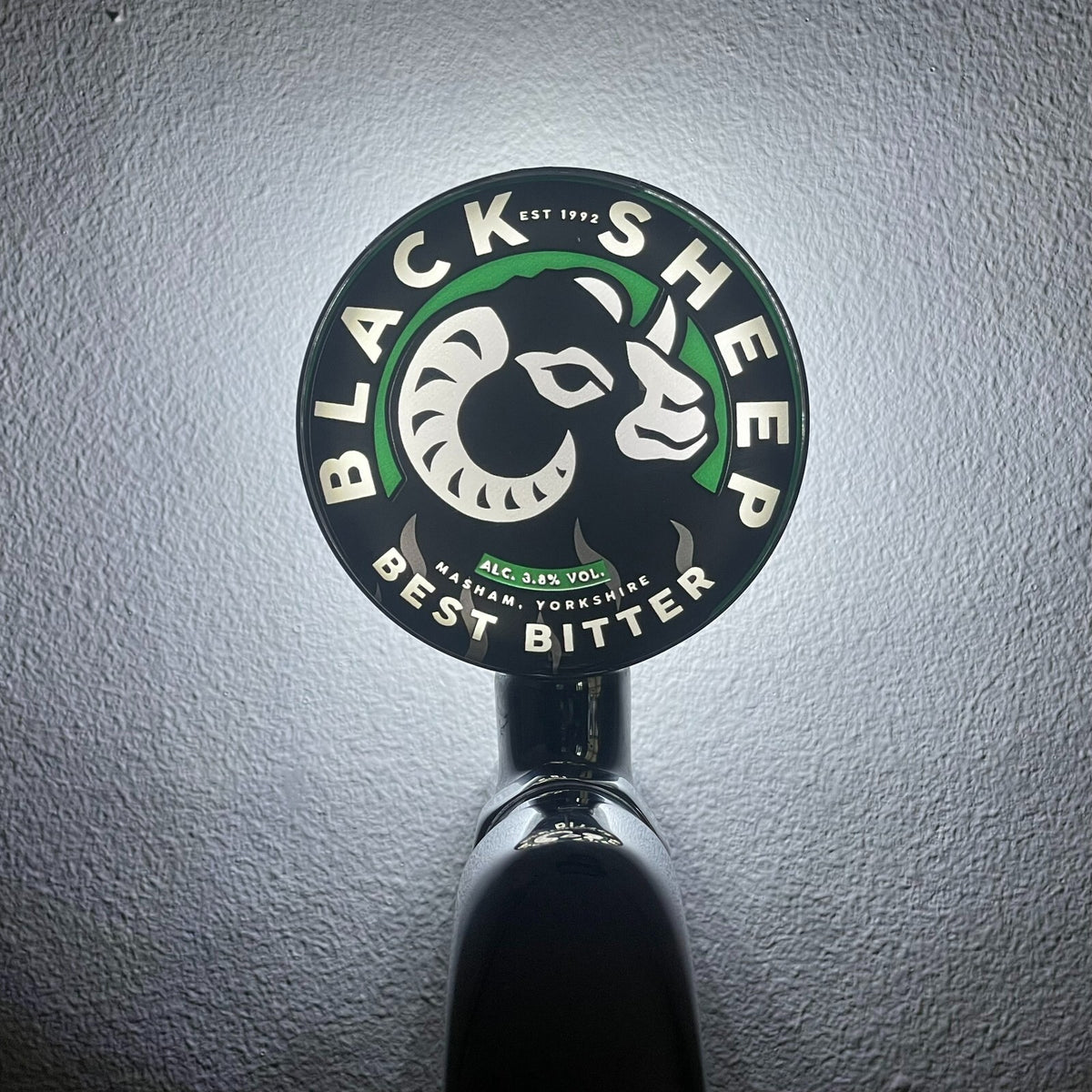 Black Sheep Best Bitter badge lit up on a beer tap