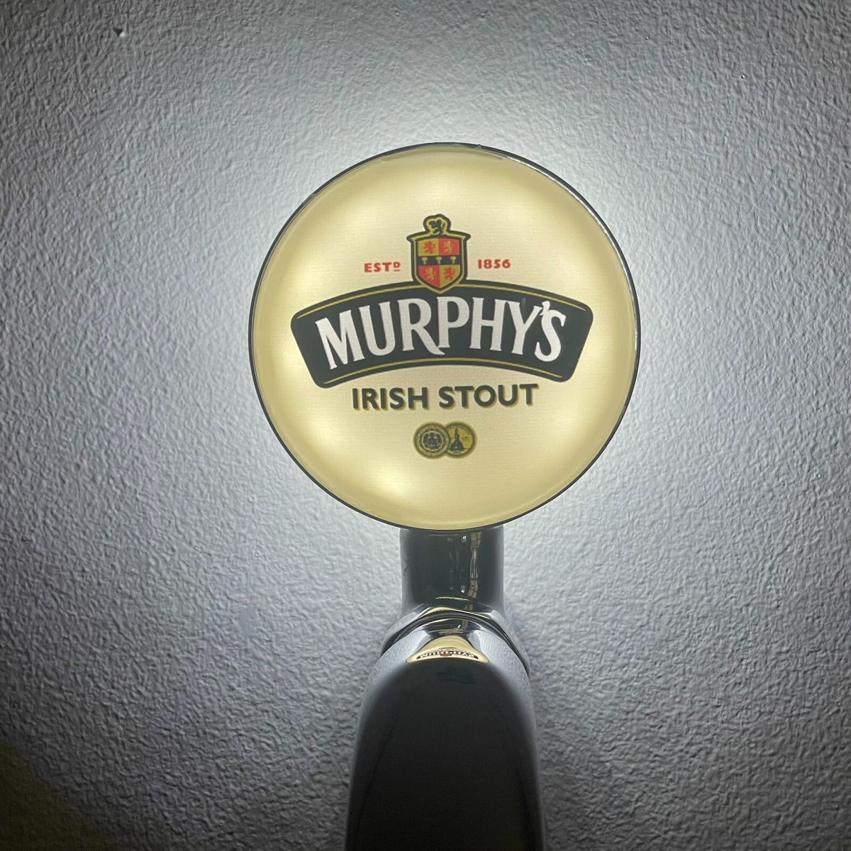 Murphy's badge lit up on a beer tap