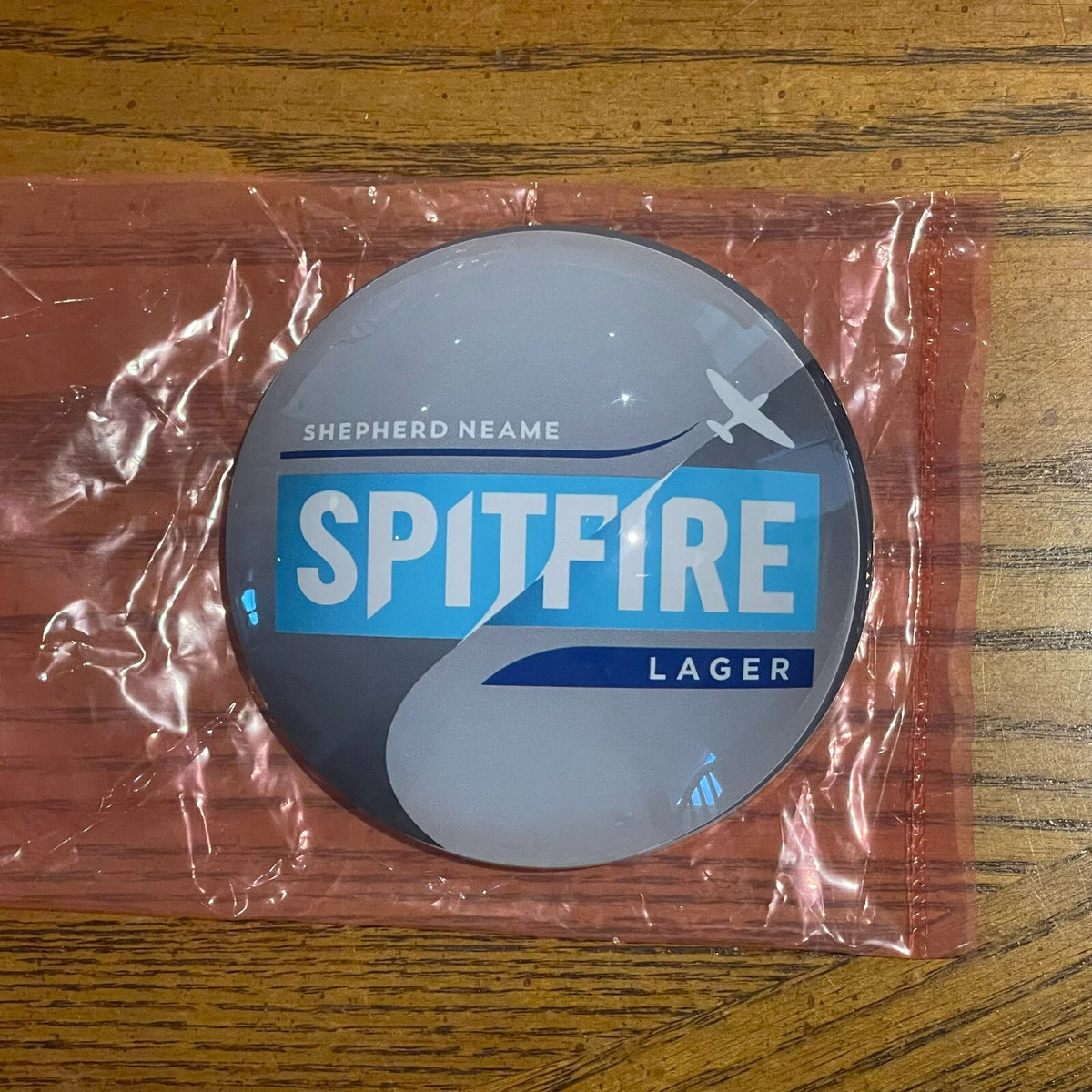 Spitfire Lager badge in its packaging