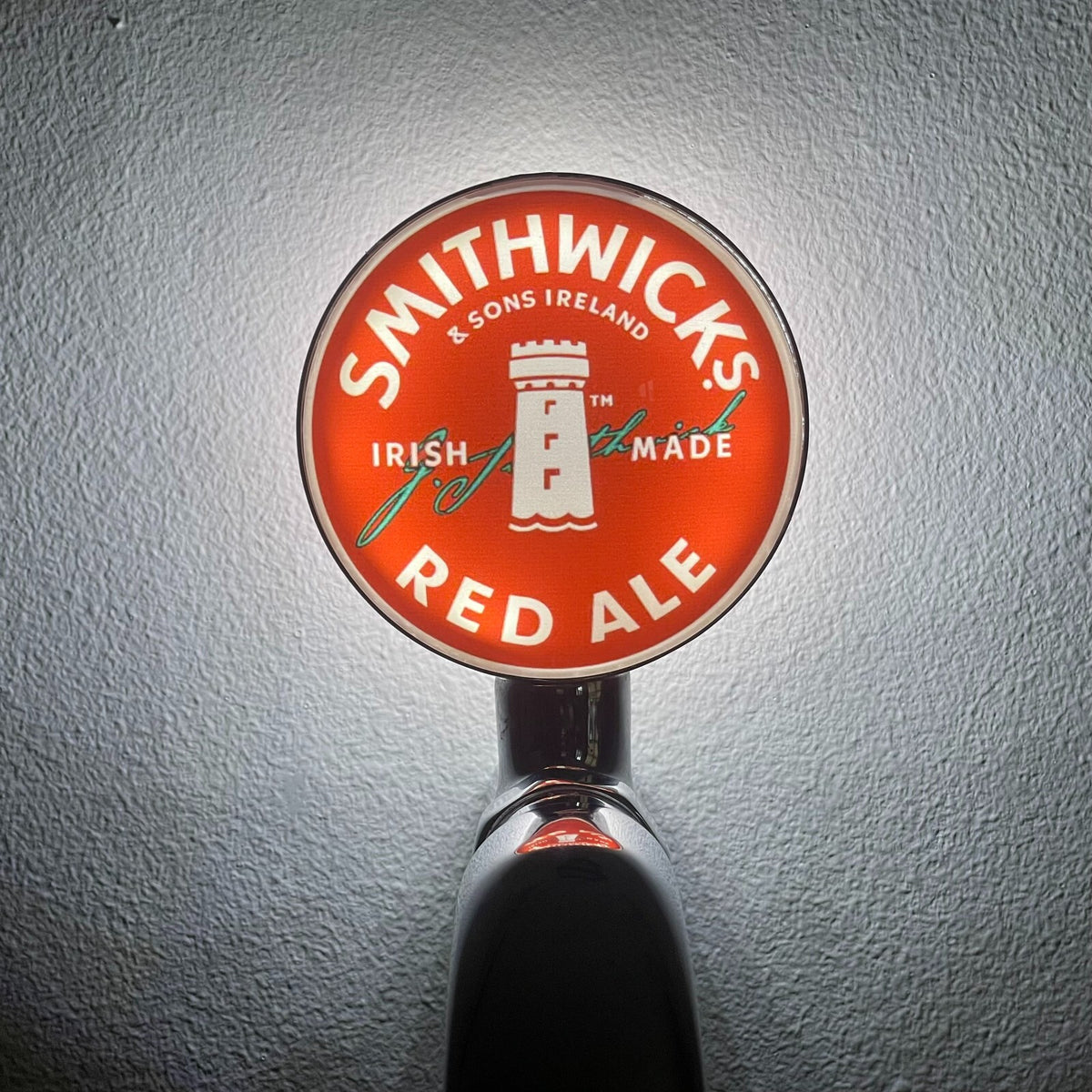 Smithwick's badge lit up on a beer tap