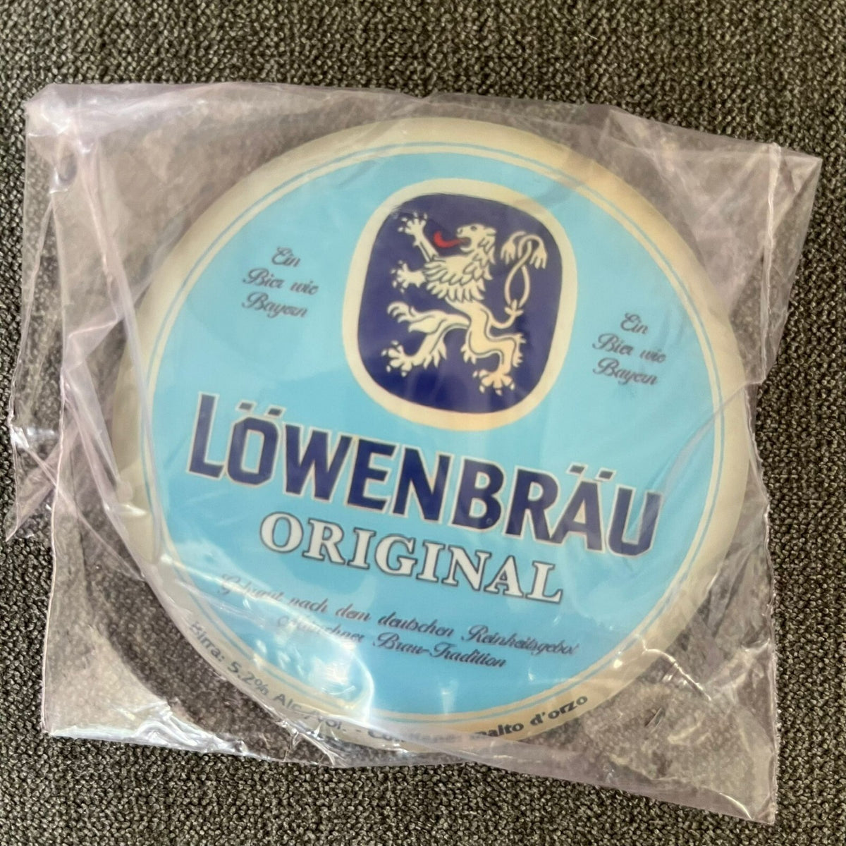 Löwenbräu badge in its packaging